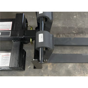Close-up of Star Industries 1390-FM forklift attachment fork blades on concrete floor