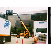 Star Industries 1420 1425 1430 yellow telescopic handler lifting operator platform near United Van Lines trucks