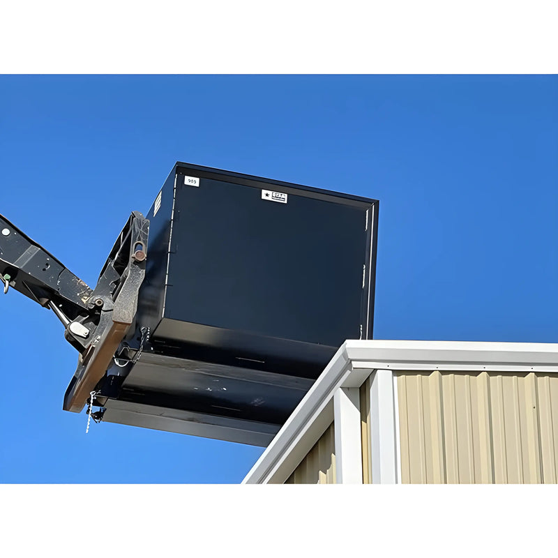 Black heavy-duty industrial bin lifted by machinery against clear blue sky Star Industries 1420 1425 1430