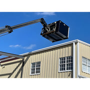 Star Industries 1420 1425 1430 aerial lift platform extended next to beige metal building under clear blue sky