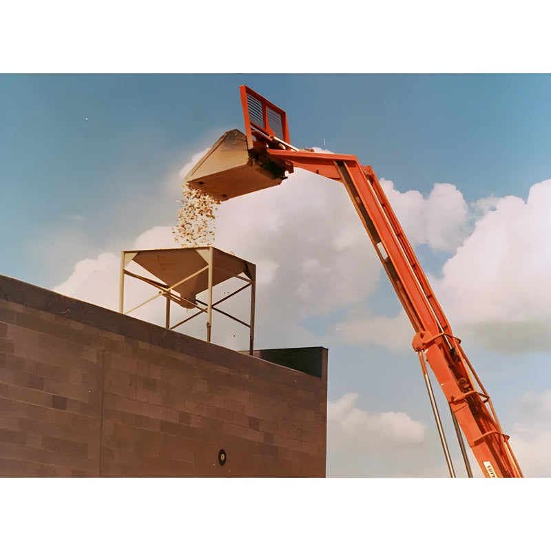 Star Industries 1472 orange construction machine dumping gravel into a hopper against blue sky