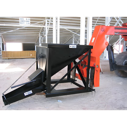 Star Industries 1575 black steel hopper attachment connected to orange heavy machinery in warehouse
