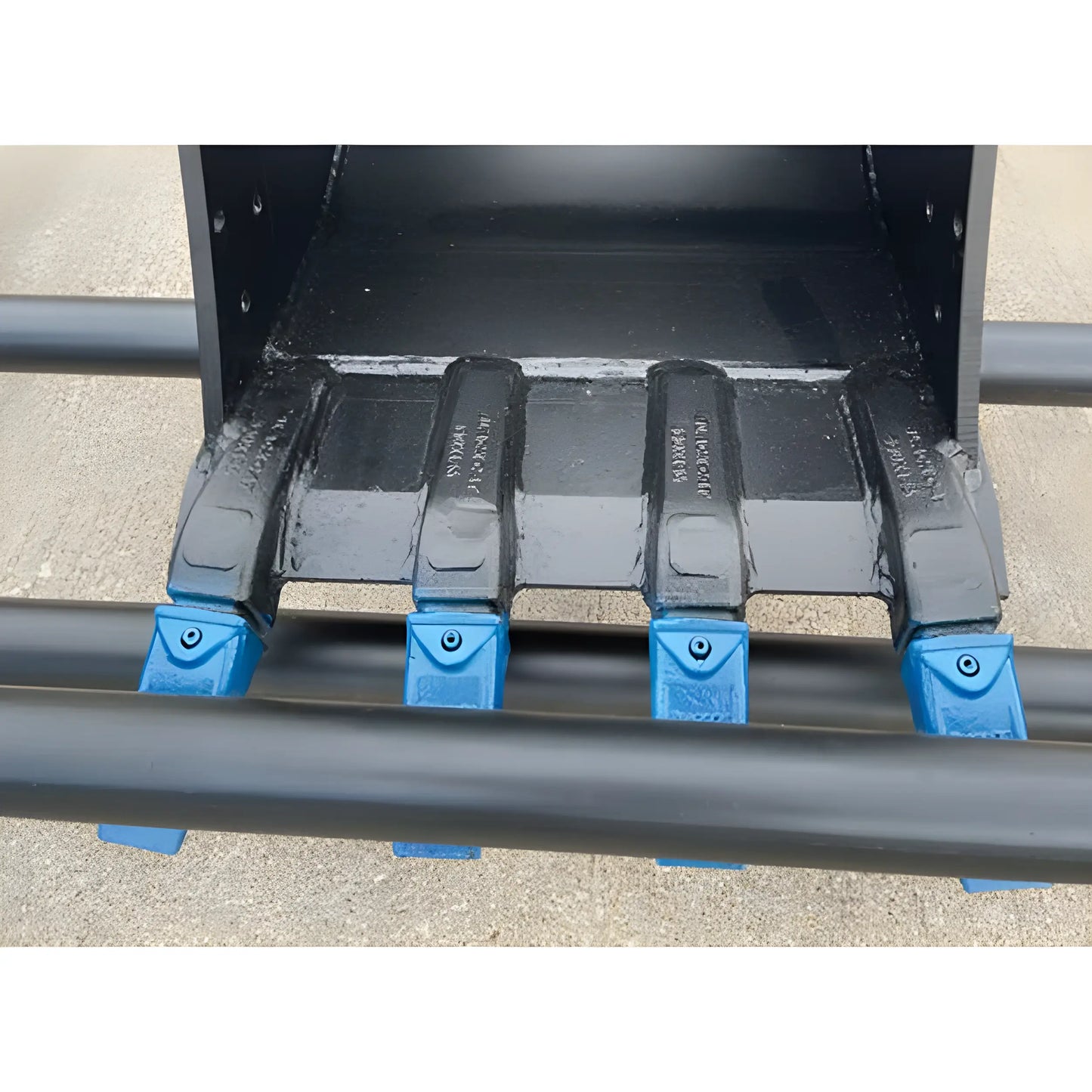 Close-up of black bucket teeth with blue tips on Star Industries 910-12 910-12T attachment