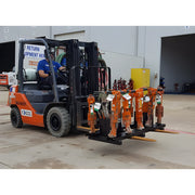 Star Industries 920 forklift carrying multiple orange hydraulic tools in industrial warehouse