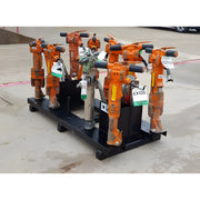 Set of orange and gray Star Industries 920 pneumatic tools on a black metal rack outdoors
