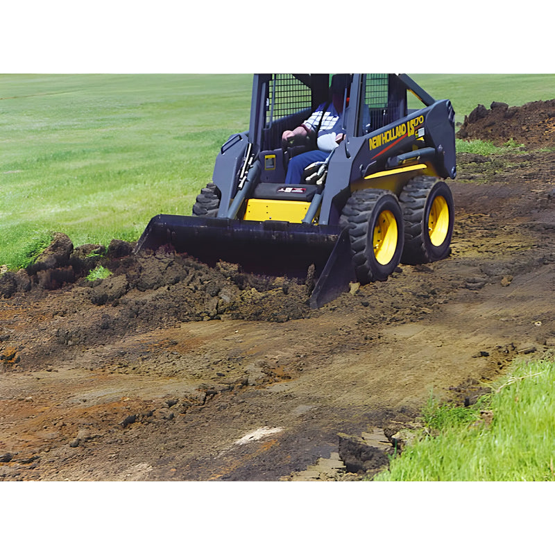 Star Industries LP22A-60 skid steer loader moving dirt on a construction site with green grass background